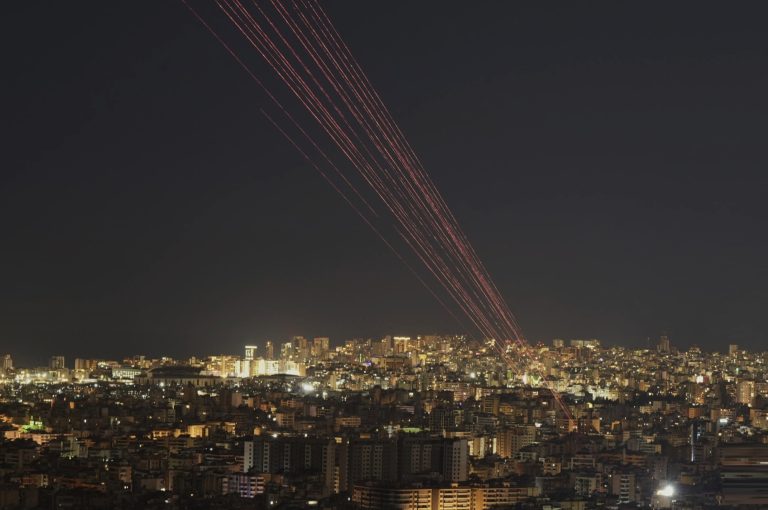 Tracer rounds light up the sky as people fire live rounds into the air during a televised speech by Hezbollah leader Naim Qassem in Dahiyeh,