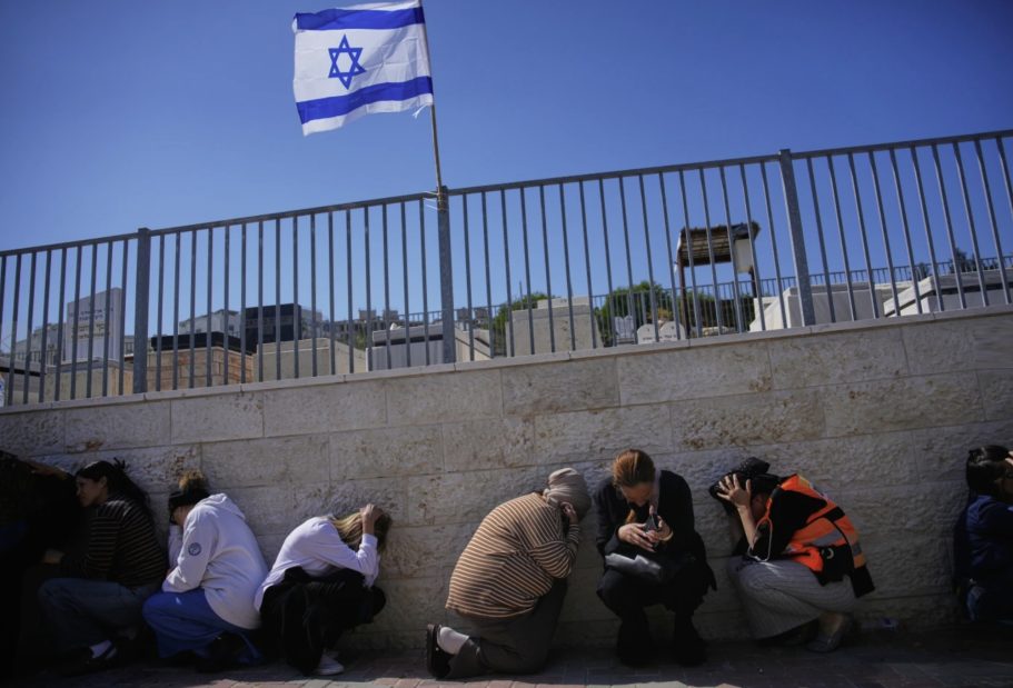 Mourners take cover as air raid sirens