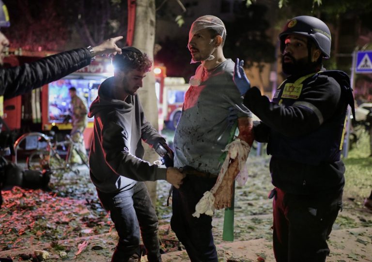 Rescuers bandage a wounded man and provide first aid